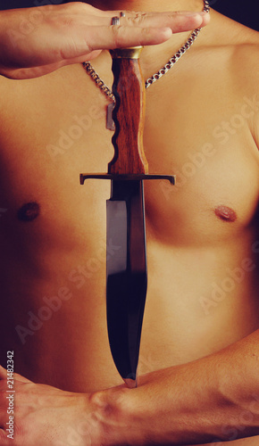torso and knife in hands photo