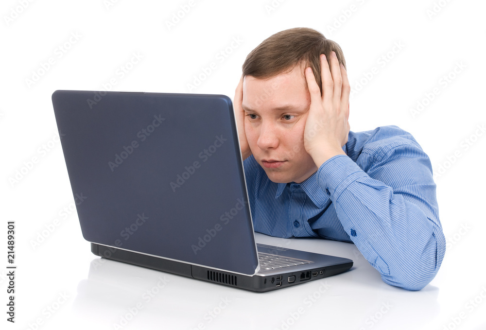 A businessman holds his head in his hands in desperation A businessman holds his head in his hands in desperation