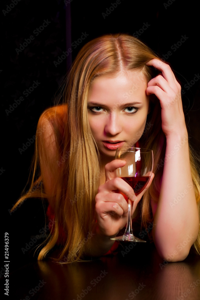 Young woman lying on a bar counter. Young woman lying on a bar counter.