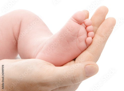 Mother holding her newborn's foot