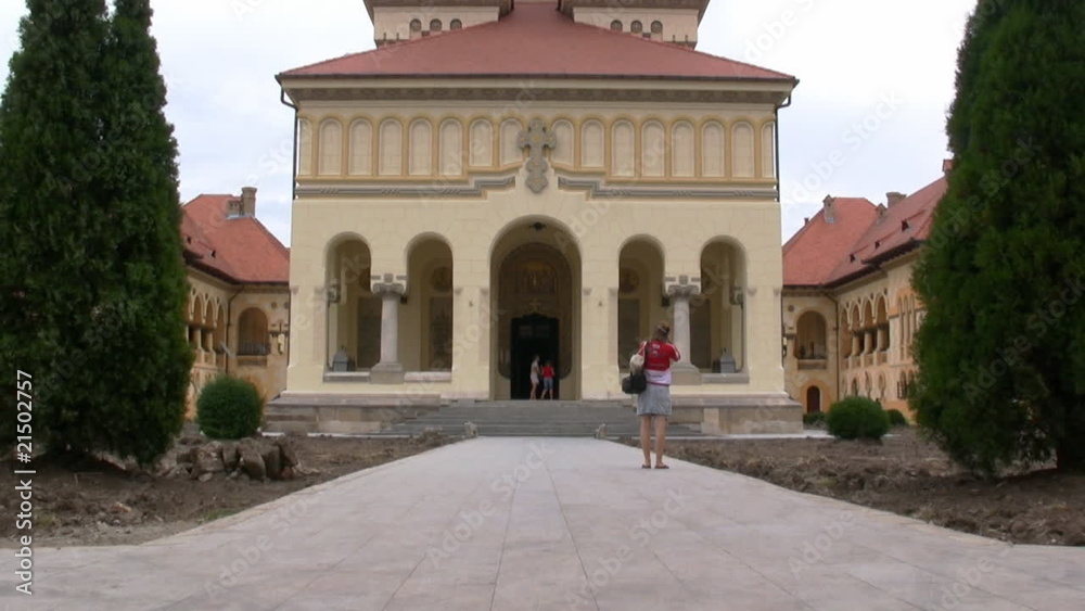 Tourist taking pictures to a church, zoom out Tourist taking pictures to a church, zoom out