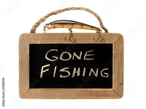 Fishing lure on top of gone fishing sign