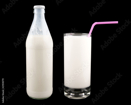 Bottle and glass of milk with pink straw on black