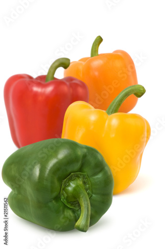 Green,red,yellow and orange pepper on white background