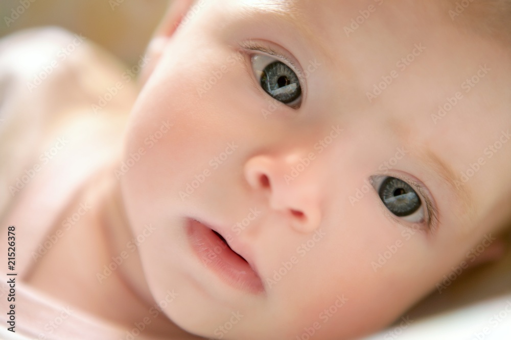 Blond little baby laying on bed portrait Blond little baby laying on bed portrait