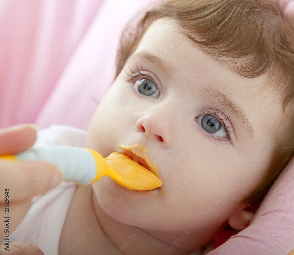 mother feeding baby yellow spoon mother feeding baby yellow spoon