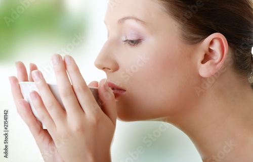 Woman with clean face drinking grean tea