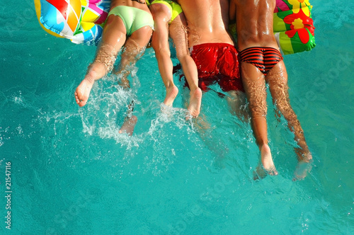 People in color swimming trunks on a mattress