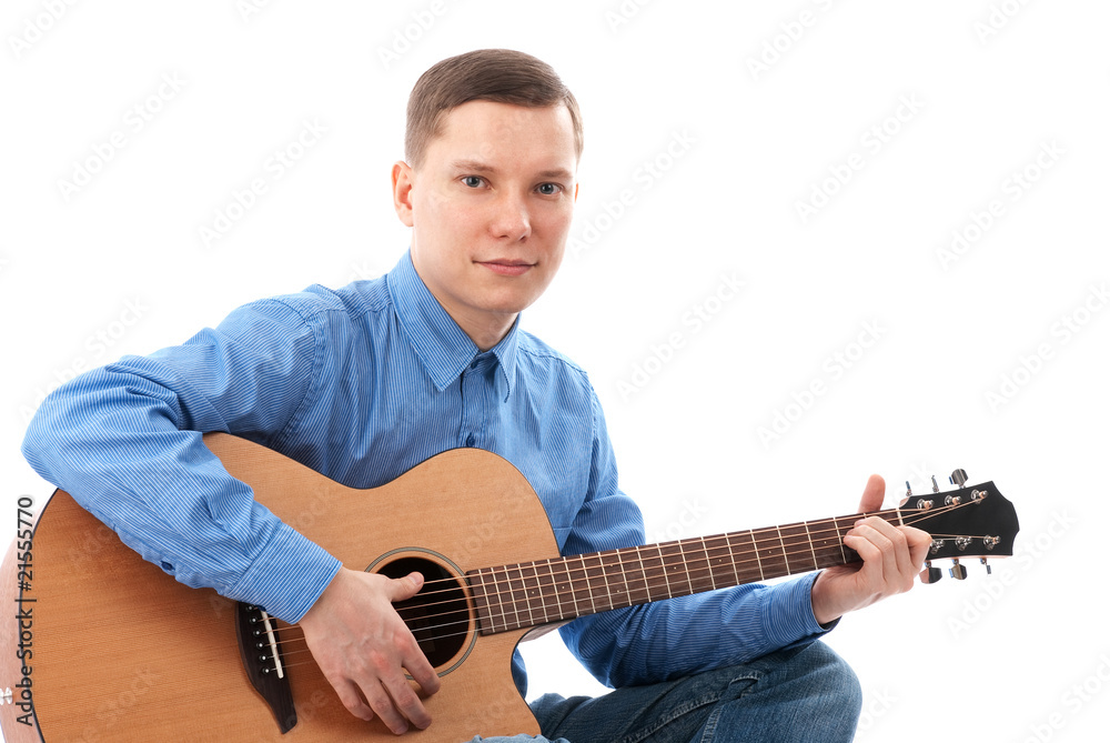 Obraz premium Young man playing an acoustic guitar