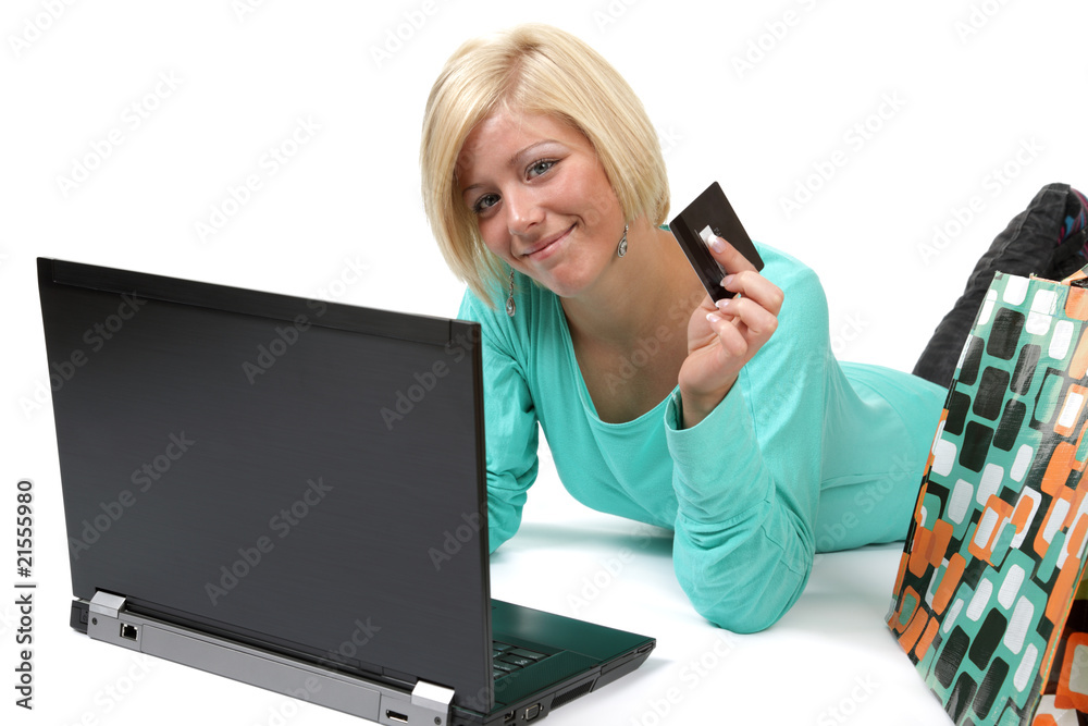 Smiling young woman holding credit card using laptop Smiling young woman holding credit card using laptop