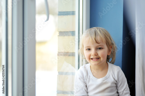 girl sits at window