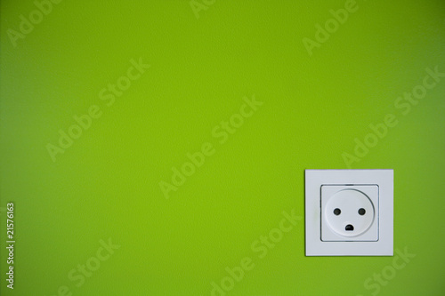 Sad wall outlet on lime green wall