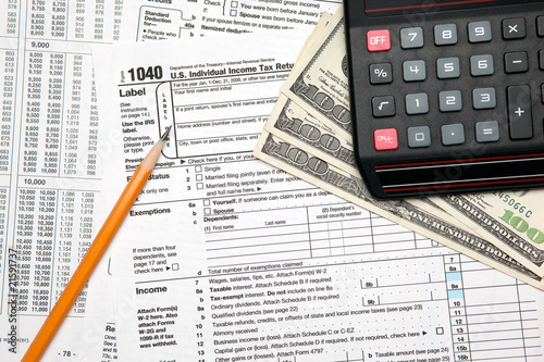 Tax time - U.S. 1040 tax return with pencil and calculator