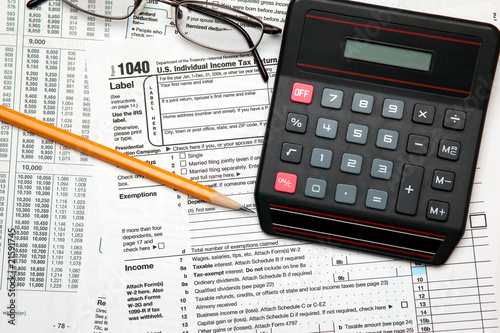 Tax time - Closeup of U.S. 1040 tax return with pencil, glasses