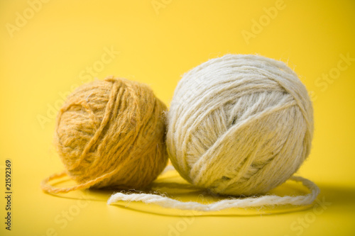 white and yellow balls of yarn on a yellow background
