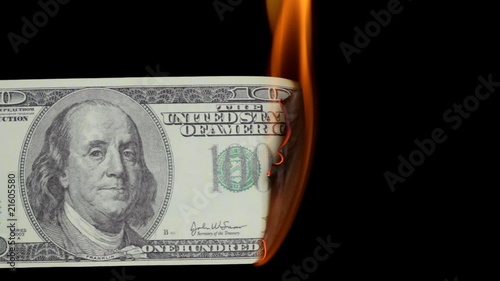 HD video of burning dollars over black background