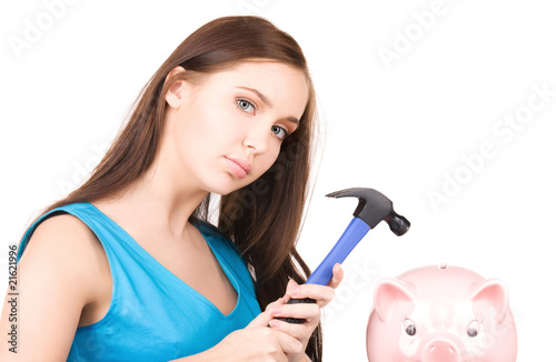 teenage girl with piggy bank and hammer