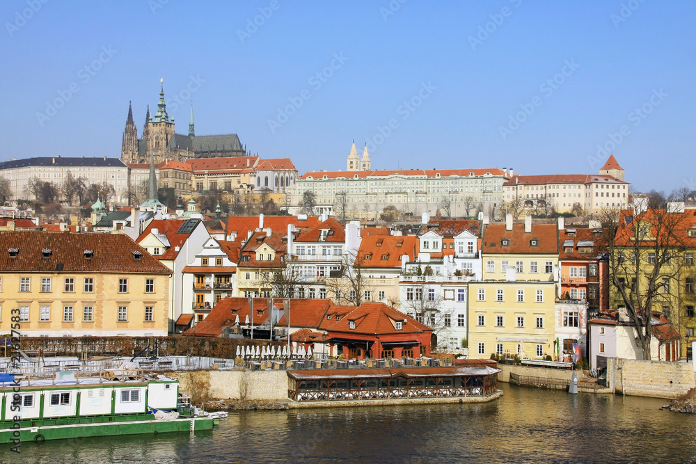 The snowy Prague gothic Castle above the River Vltava