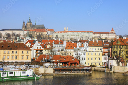 The snowy Prague gothic Castle above the River Vltava