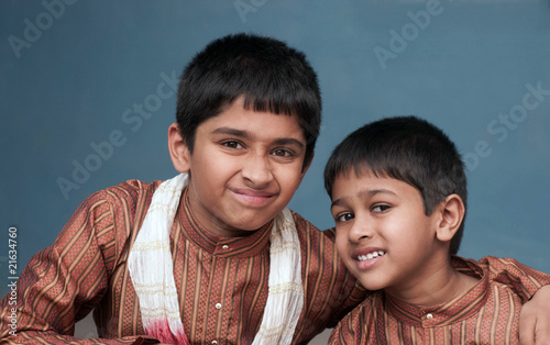 two handsome indian brothers looking happy photo