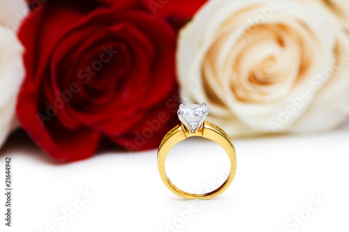 Wedding concept with roses and golden rings