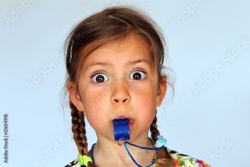 Φωτογραφία Young girl blowing a whistle as hard as she can