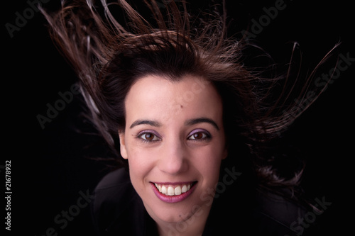 young woman from the front  with her hair in the wind