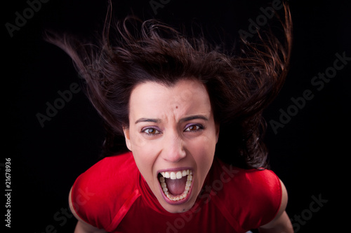 beautiful woman with her hair in the wind, screaming in fury