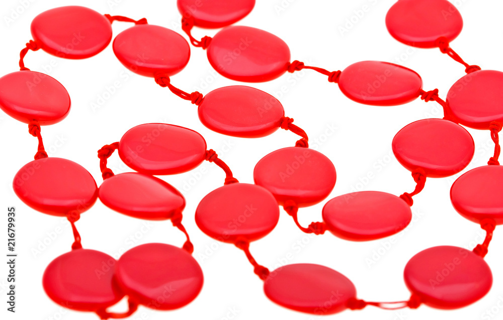 Close-up beautiful string of red beads isolated on white Close-up beautiful string of red beads isolated on white