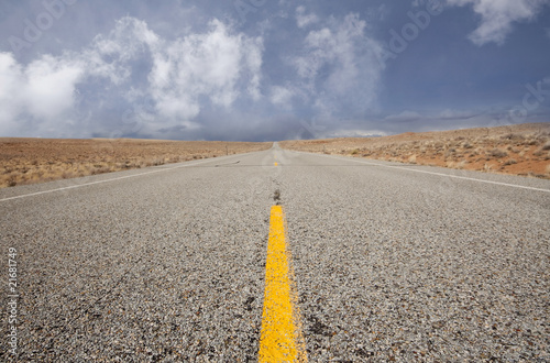 Low angle shot of a road with blue cloudy sky
