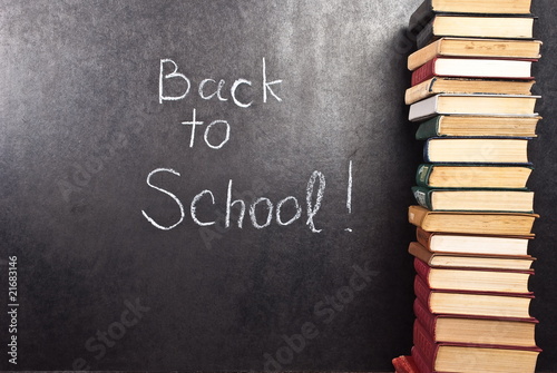 Back to school written on chalkboard witch books