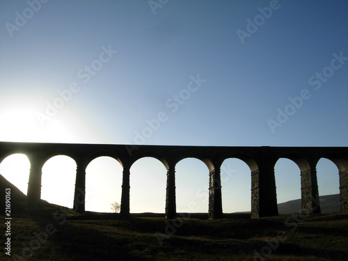 Viaduct silhouette against blue sky