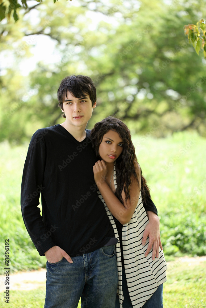 Fototapeta premium Young teen couple holding each other outdoors portrait