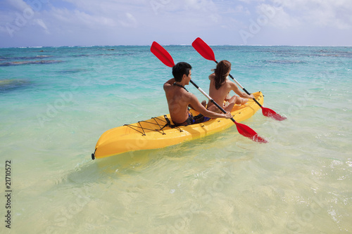 young couple kayaking in hawaii