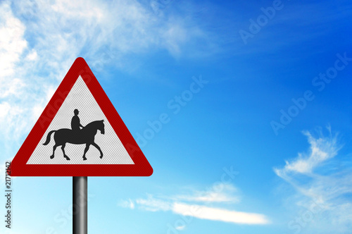 Photo realistic 'horses with riders' sign, against a bright blue