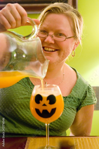 Smiling Woman Pouring Halloween Punch