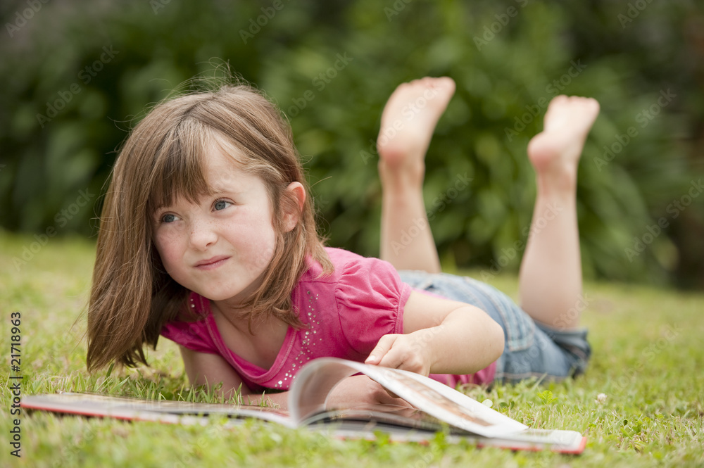 little girl laying in grass reading little girl laying in grass reading
