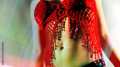 beautiful young blond woman dances in oriental style red top