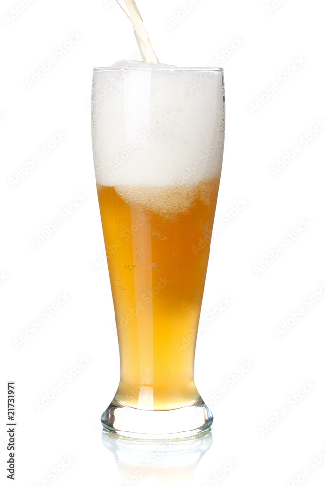 White beer is pouring into a glass from bottle White beer is pouring into a glass from bottle