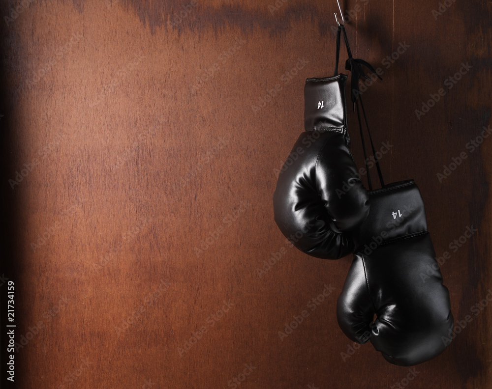 Boxing-glove hanging on wooden background