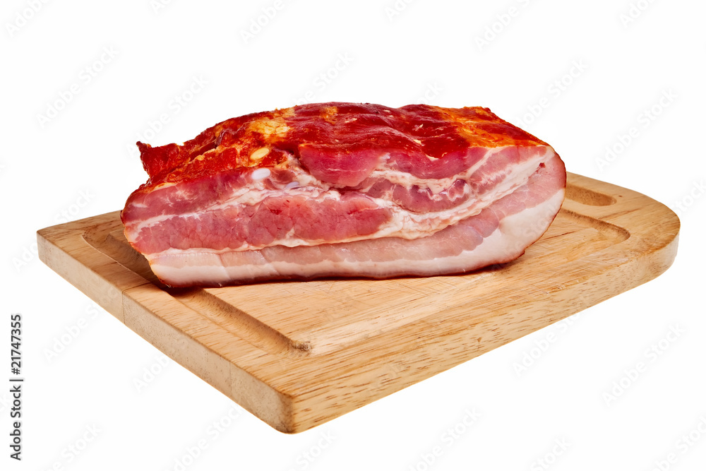 Smoked bacon on wooden board isolated over white background. Smoked bacon on wooden board isolated over white background.