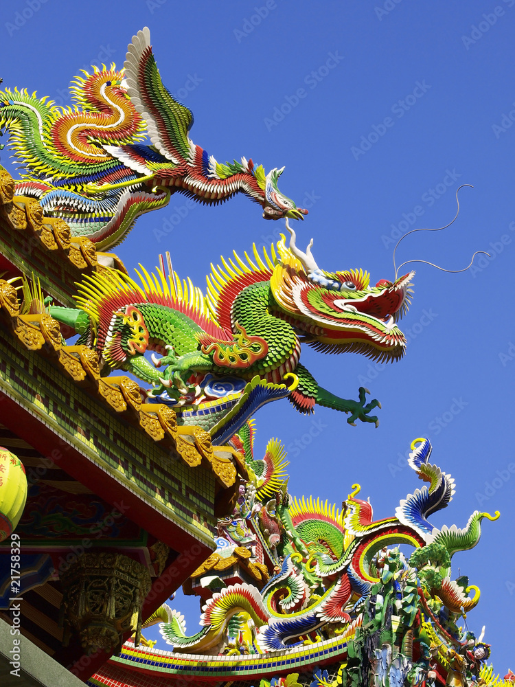 Dragon and phoenix on rooftop of Chinese temple Dragon and phoenix on rooftop of Chinese temple