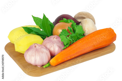 Board with potatoes, garlic, carrots, mushrooms, onions, bay lea