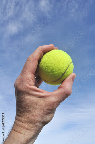 Player Gripping a Yellow Tennis Ball