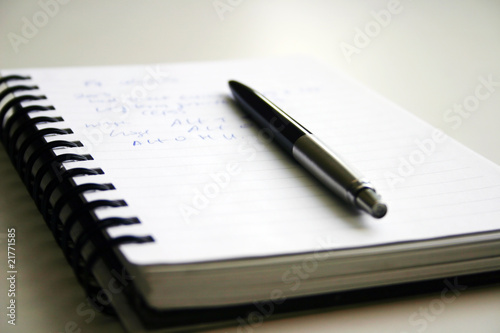 A black pen and writed notebook.