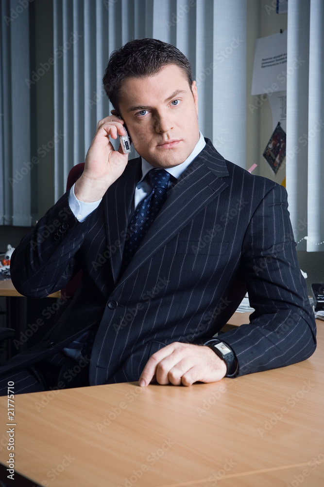 a man talking on the phone in the office a man talking on the phone in the office