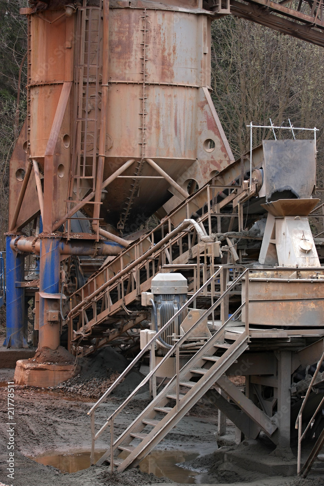 Stone quarry with silos, conveyor belts and piles of stones. Stone quarry with silos, conveyor belts and piles of stones.