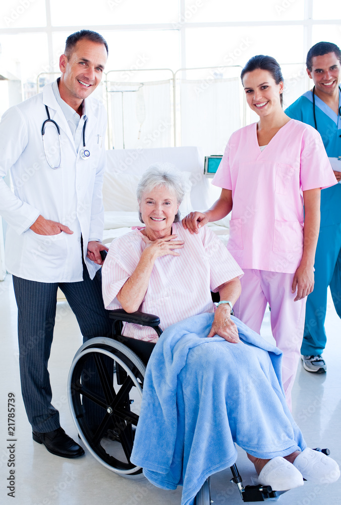 Serious medical team taking care of a senior woman