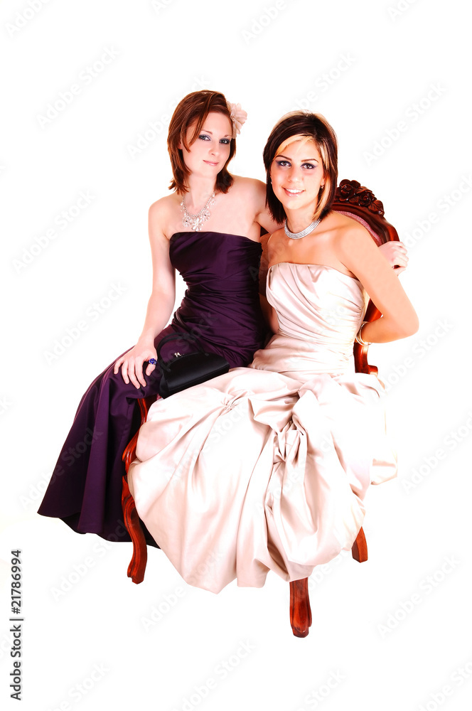 Two beautiful woman sitting in a armchair.
