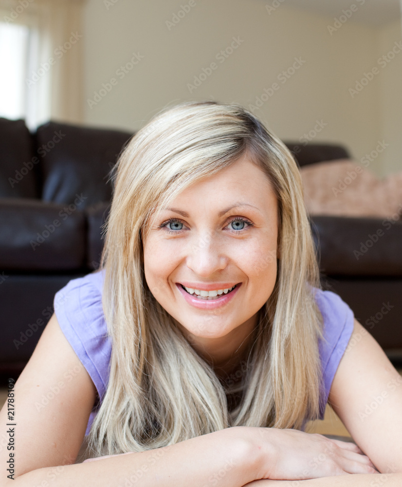 Laughing young woman lying on the floor Laughing young woman lying on the floor